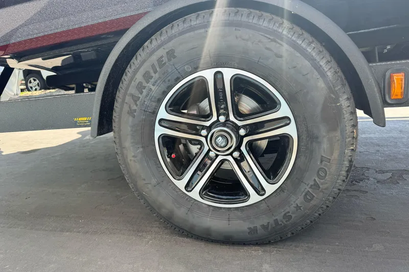 Slide: The Image of 2026 Triton 18 TrX trailer wheel with black alloy rim and Karrie tire. - 4