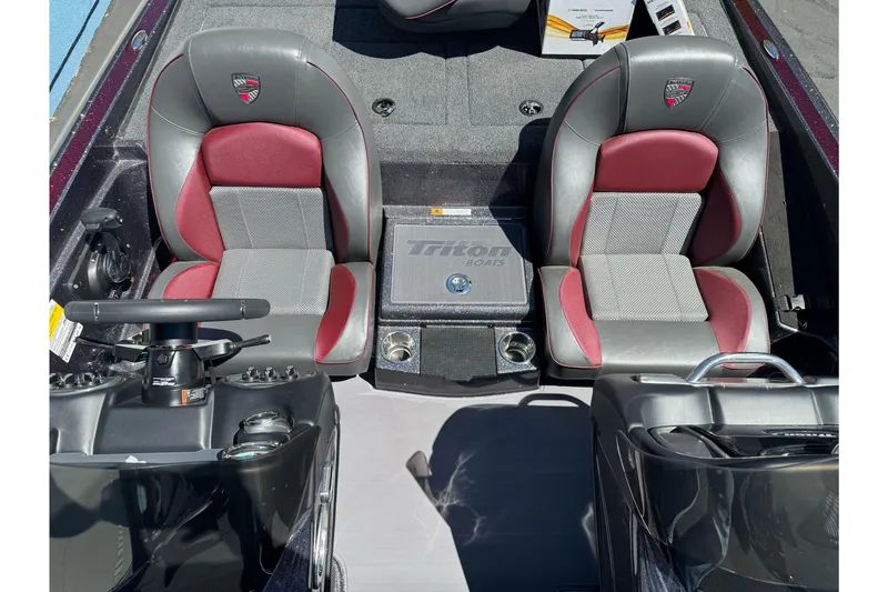 Slide: The Image of 2026 Triton 18 TrX boat interior with dual seats and steering console. - 16
