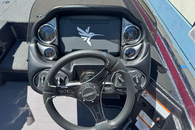 Slide: The Image of Dashboard of a 2026 Triton 18 TrX boat with steering wheel and gauges. - 20