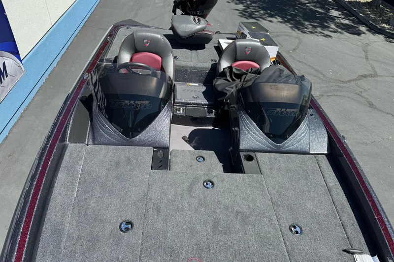 Slide: The Image of 2026 Triton 18 TrX boat interior with dual seats and steering consoles. - 13