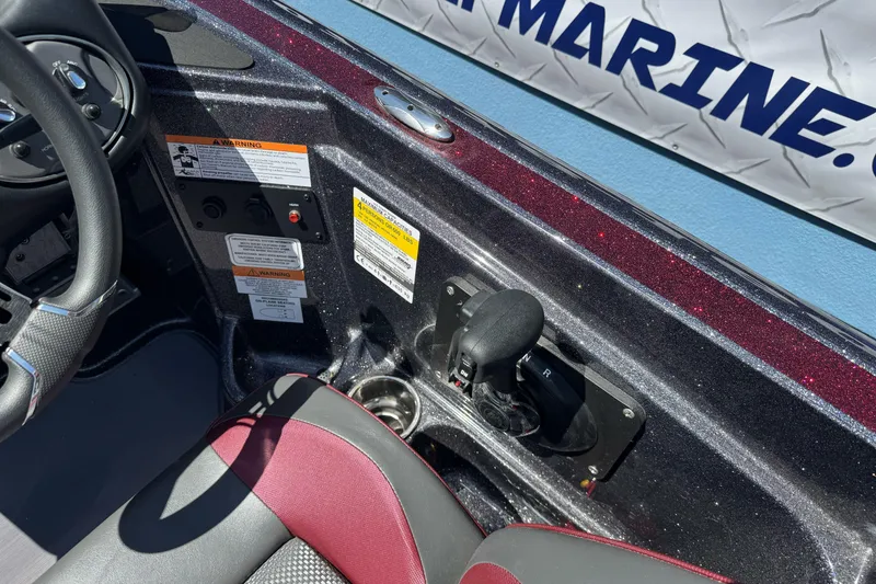 Slide: The Image of Interior of a 2026 Triton 18 TrX boat showing steering wheel and controls. - 23