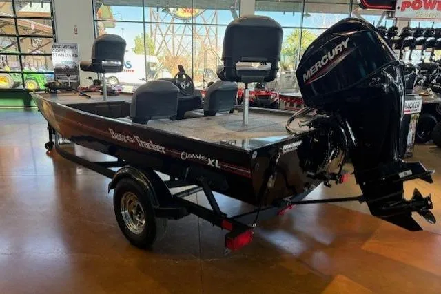 Slide: The Image of 2026 Tracker Bass Tracker Classic XL boat with Mercury engine in showroom. - 3