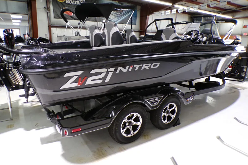 The Image of 2026 Nitro ZV21 Pro boat in showroom, sleek black design on trailer. - 0