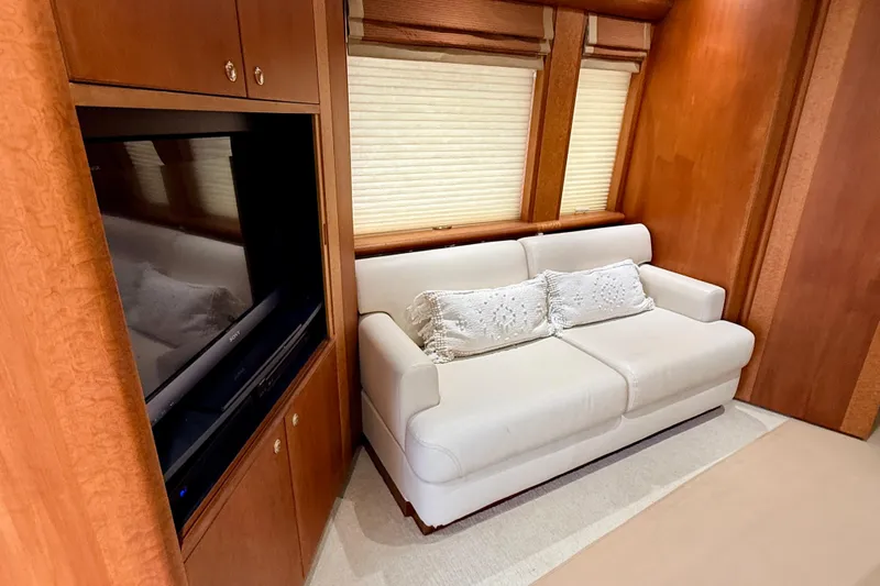 Slide: The Image of Luxurious interior of 2002 Cheoy Lee 72 Yacht with white sofa and wood paneling. - 10