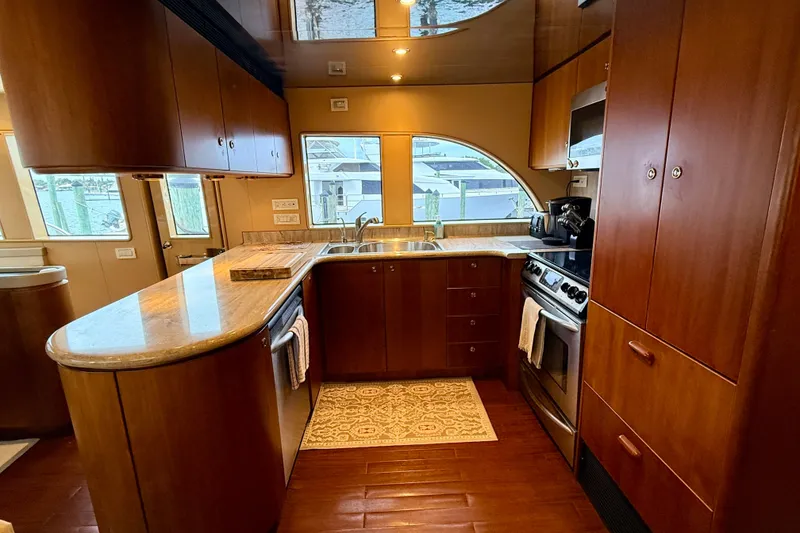 Slide: The Image of Luxurious kitchen in 2002 Cheoy Lee 72 Raised Pilot House Motor Yacht, featuring wood cabinetry and modern appliances. - 12