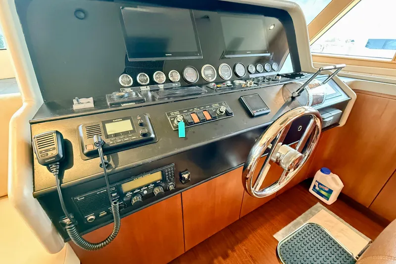 Slide: The Image of Pilot house of 2002 Cheoy Lee 72 Yacht with navigation instruments and steering wheel. - 19