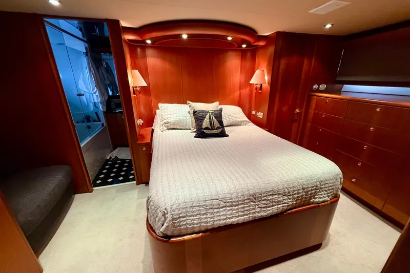 Slide: The Image of Luxurious bedroom in 2002 Cheoy Lee 72 Raised Pilot House Motor Yacht, featuring elegant wood finishes. - 22