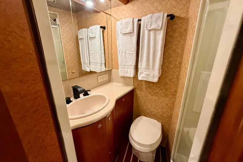 Slide: The Image of Luxurious bathroom in 2002 Cheoy Lee 72 Raised Pilot House Motor Yacht, featuring elegant fixtures and towels. - 35