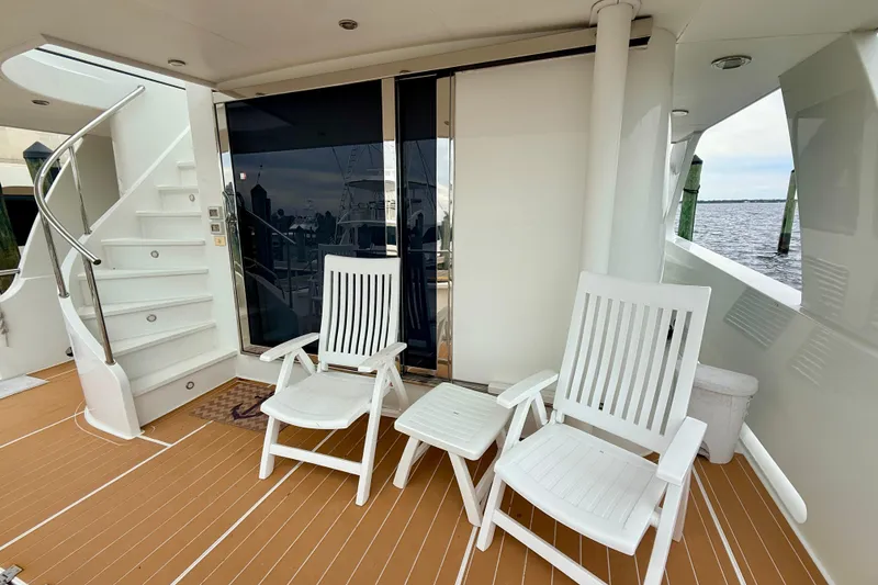 Slide: The Image of Deck of 2002 Cheoy Lee 72 Yacht with white chairs and ocean view. - 5