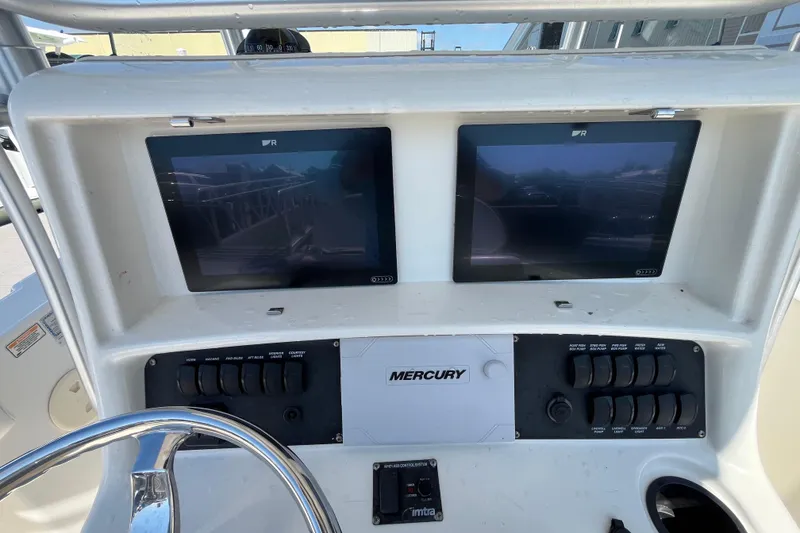 Slide: The Image of 2007 Boston Whaler 270 Outrage dashboard with dual screens and Mercury controls. - 14