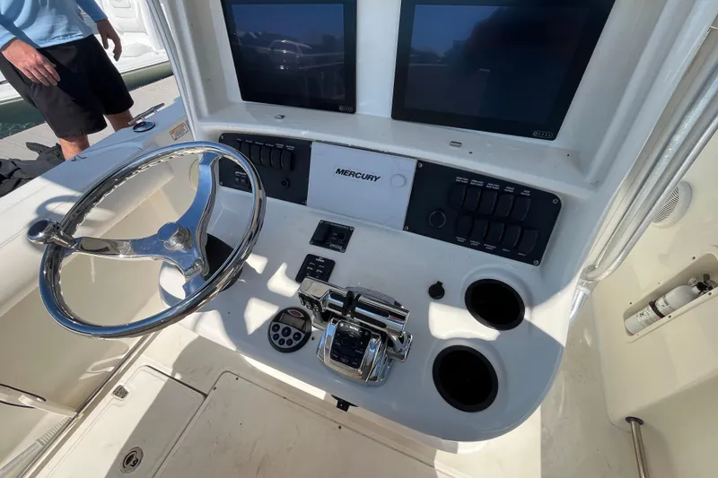 Slide: The Image of 2007 Boston Whaler 270 Outrage boat console with steering wheel and controls. - 15