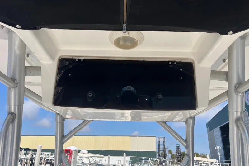 Slide: The Image of 2007 Boston Whaler 270 Outrage T-top with electronics box, marina background. - 17