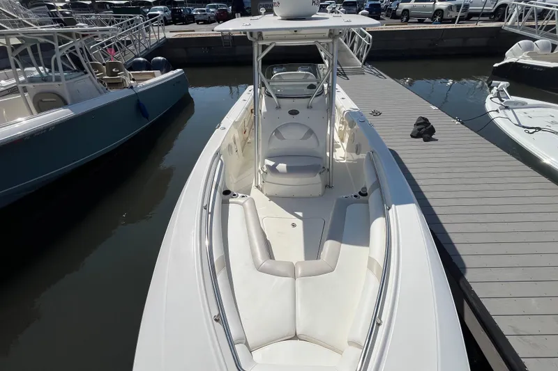 Slide: The Image of 2007 Boston Whaler 270 Outrage docked, showcasing spacious seating and sleek design. - 18