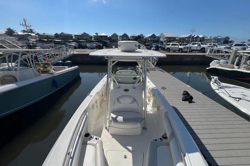 Slide: The Image of 2007 Boston Whaler 270 Outrage docked at marina under clear blue sky. - 19