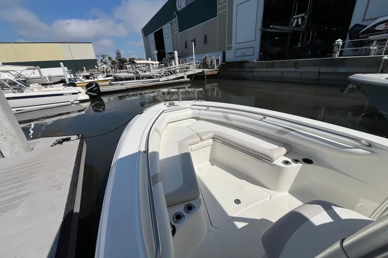 Slide: The Image of 2007 Boston Whaler 270 Outrage docked at marina, showcasing spacious seating and sleek design. - 21