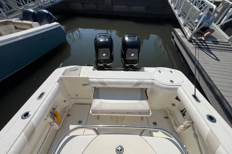 Slide: The Image of 2007 Boston Whaler 270 Outrage boat with dual engines docked at marina. - 23