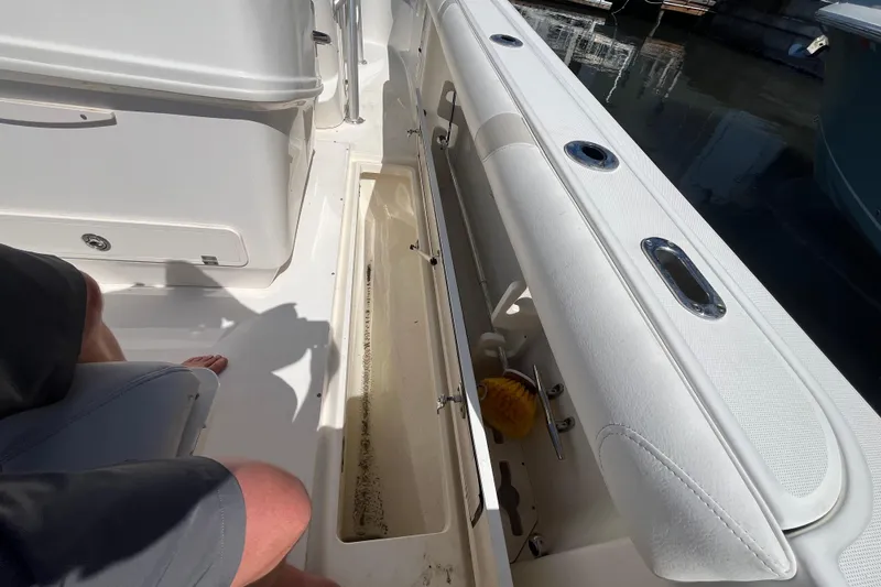 Slide: The Image of 2007 Boston Whaler 270 Outrage interior with storage compartment and seating detail. - 24