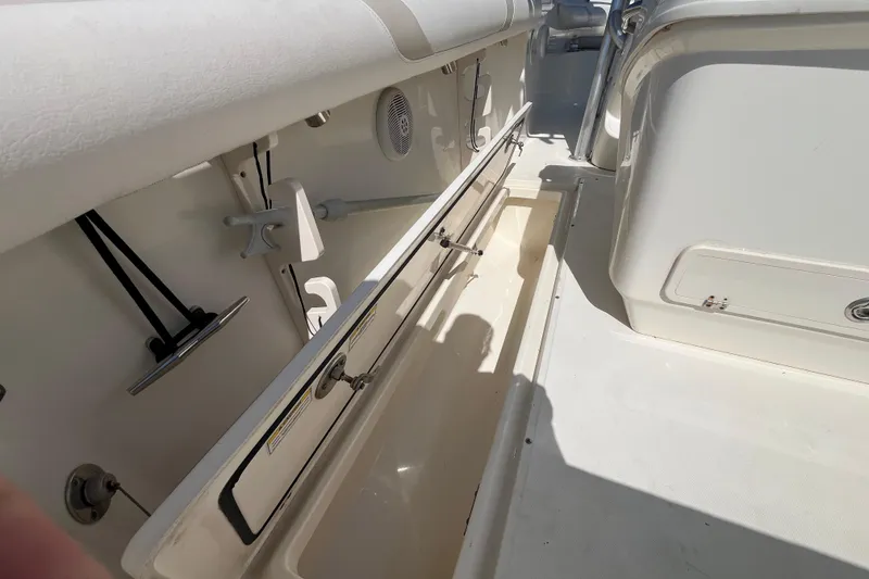 Slide: The Image of 2007 Boston Whaler 270 Outrage interior, showcasing storage compartments and seating area. - 25
