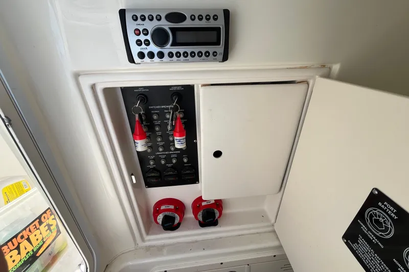 Slide: The Image of 2007 Boston Whaler 270 Outrage control panel with stereo and switches. - 28