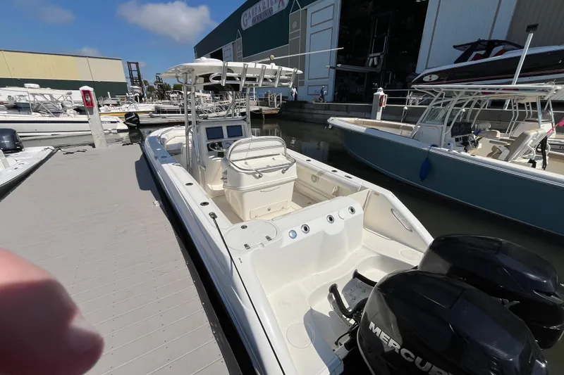 Slide: The Image of 2007 Boston Whaler 270 Outrage docked, featuring dual Mercury engines and spacious deck. - 30