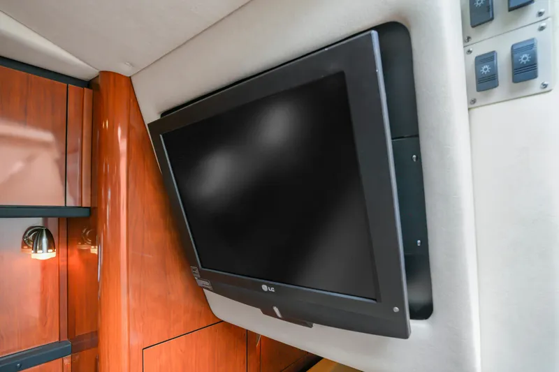 Slide: The Image of Flat-screen TV in 2007 Sea Ray 310 Sundancer cabin with wood paneling. - 13
