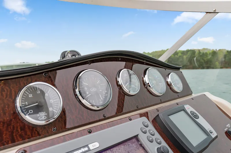 Slide: The Image of Dashboard of a 2007 Sea Ray 310 Sundancer boat with gauges and navigation equipment. - 22