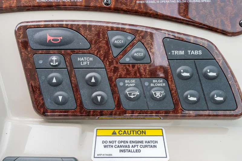 Slide: The Image of Control panel of a 2007 Sea Ray 310 Sundancer with various switches and caution label. - 25