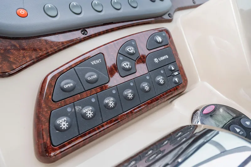 Slide: The Image of Control panel of a 2007 Sea Ray 310 Sundancer boat with various switches. - 27