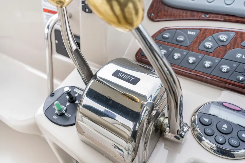 Slide: The Image of Control panel of 2007 Sea Ray 310 Sundancer boat with shift lever and buttons. - 29