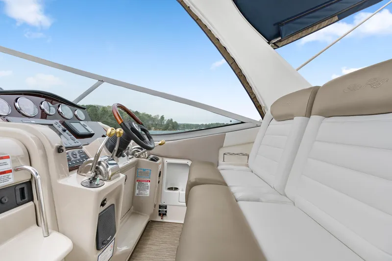 Slide: The Image of 2007 Sea Ray 310 Sundancer cockpit with beige seating and modern controls. - 30