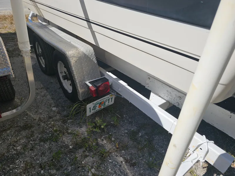 Slide: The Image of 2002 Godfrey Hurricane Sundeck 187 on trailer, Florida license plate. - 23