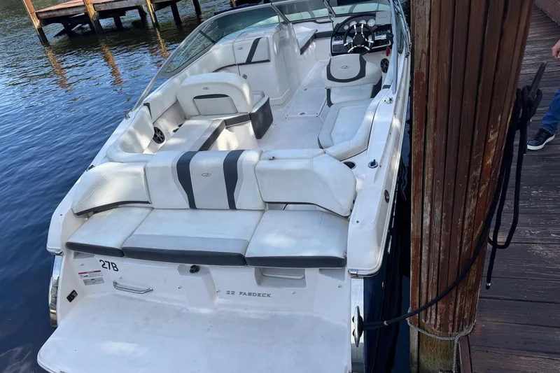 Slide: The Image of 2017 Regal 22 FasDeck boat docked, featuring spacious seating and sleek design. - 2