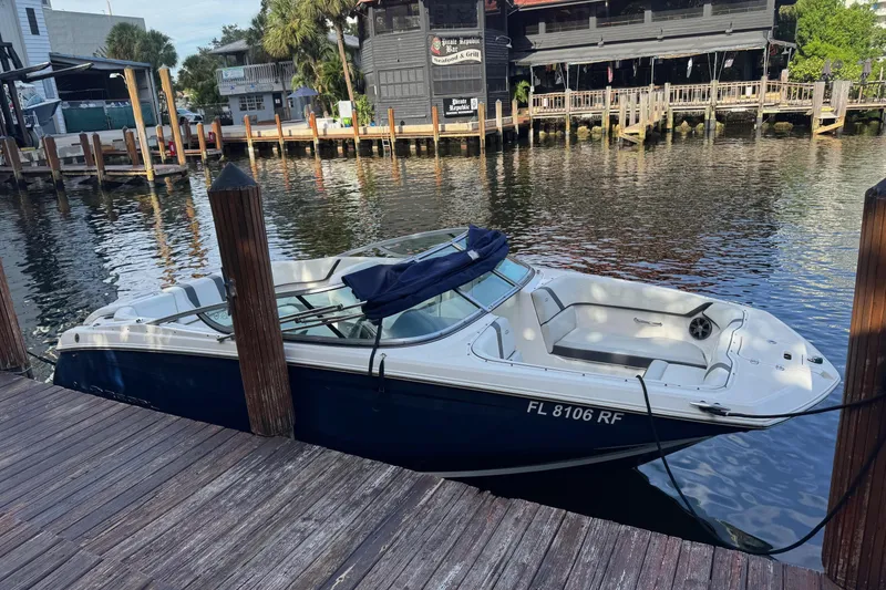 Slide: The Image of 2017 Regal 22 FasDeck boat docked by waterfront restaurant. - 3