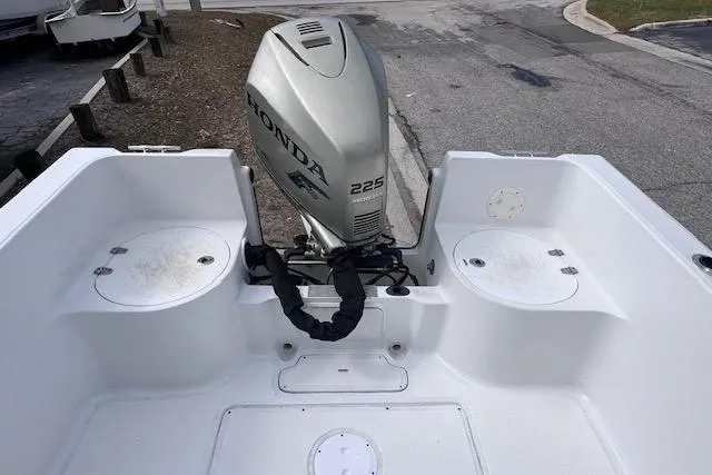 Slide: The Image of 2008 Angler PANGA 22 boat with Honda 225 outboard motor, docked on a paved surface. - 11