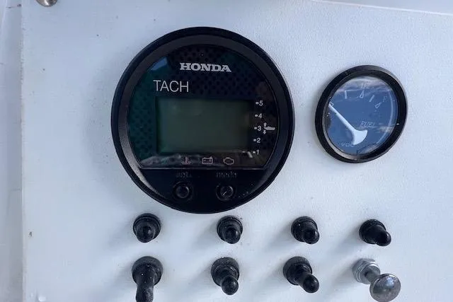 Slide: The Image of Control panel of a 2008 Angler PANGA 22 with Honda tachometer and fuel gauge. - 17