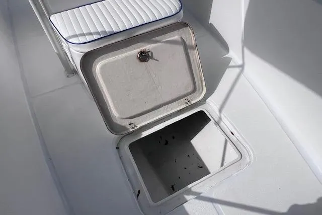 Slide: The Image of Open storage compartment on 2008 Angler PANGA 22 boat with cushioned seating. - 23