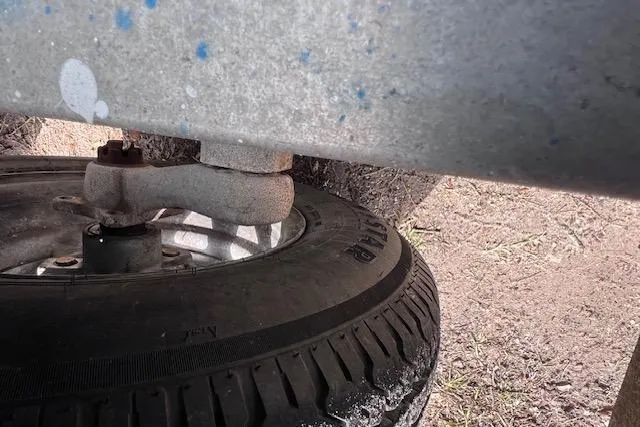 Slide: The Image of Close-up of a 2008 Angler PANGA 22 trailer wheel and suspension system. - 31