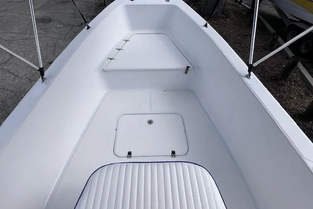 Slide: The Image of 2008 Angler PANGA 22 boat interior with white seating and storage compartments. - 18