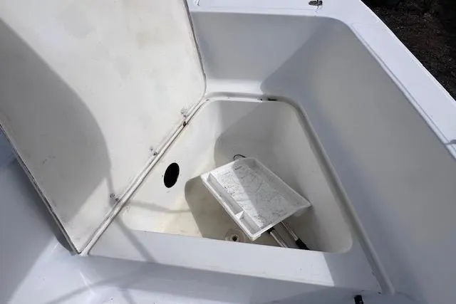Slide: The Image of Open storage compartment on 2008 Angler PANGA 22 boat, featuring a white interior. - 24
