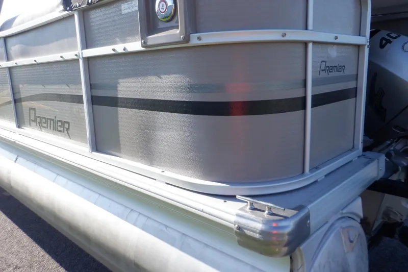 Slide: The Image of 2009 Premier 225 Sunsation LTD pontoon boat, silver exterior, close-up view. - 11
