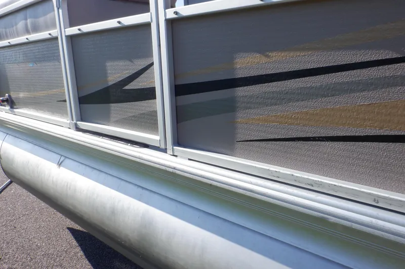 Slide: The Image of 2009 Premier 225 Sunsation LTD pontoon boat side view with decorative graphics. - 12