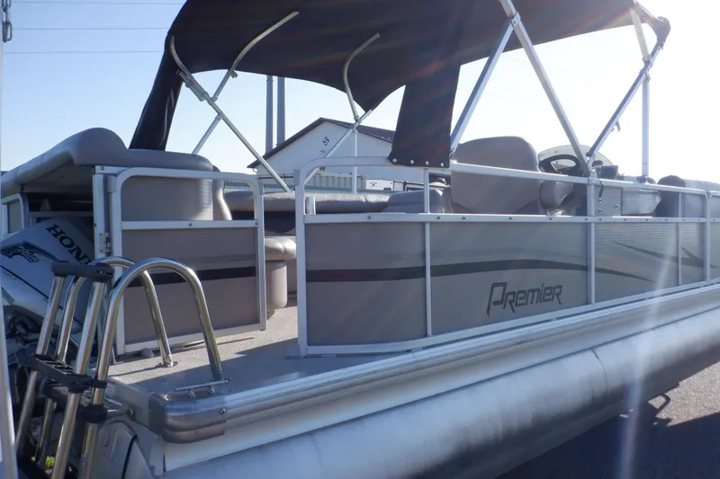 Slide: The Image of 2009 Premier 225 Sunsation LTD pontoon boat with canopy and Honda outboard motor. - 2