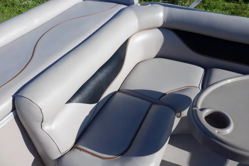 Slide: The Image of 2009 Premier 225 Sunsation LTD boat interior with gray seating and table. - 20