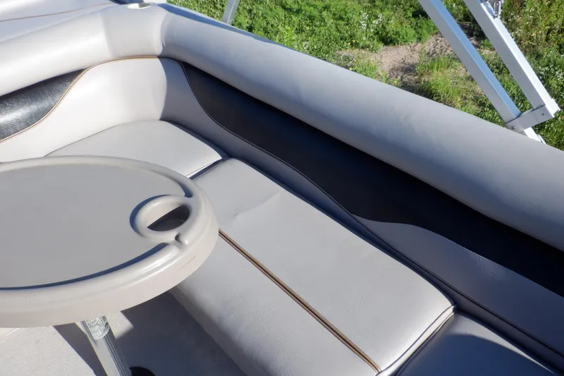 Slide: The Image of 2009 Premier 225 Sunsation LTD boat interior with cushioned seating and table. - 21