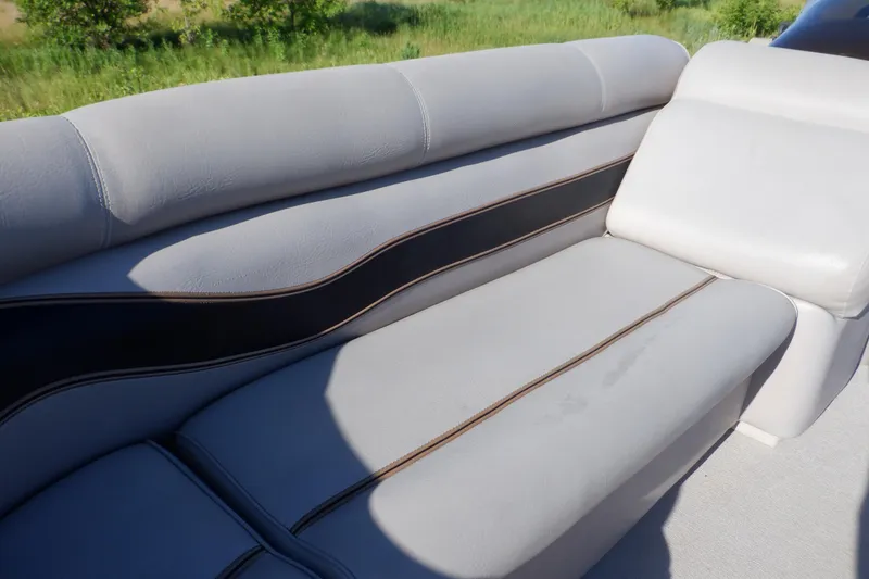 Slide: The Image of 2009 Premier 225 Sunsation LTD boat seat with light gray upholstery and black accents. - 24