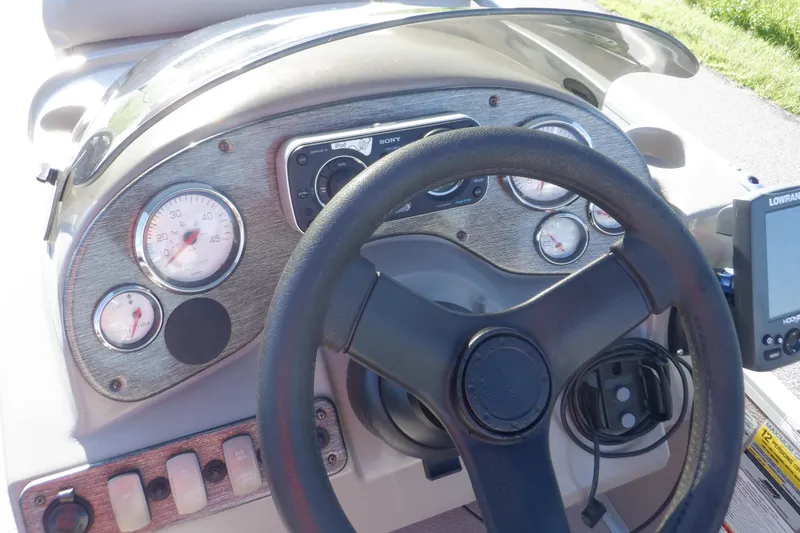 Slide: The Image of Dashboard of 2009 Premier 225 Sunsation LTD boat with steering wheel and gauges. - 27