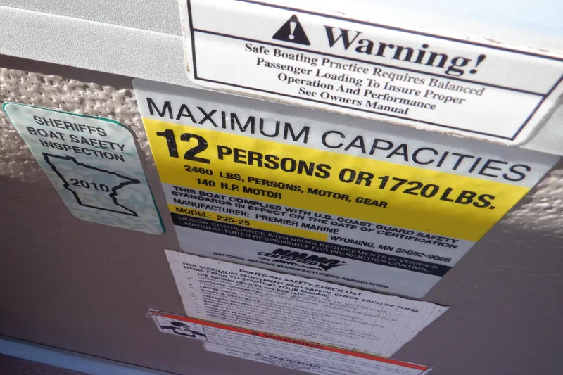 Slide: The Image of Warning label on 2009 Premier 225 Sunsation LTD boat showing maximum capacity and safety inspection. - 30