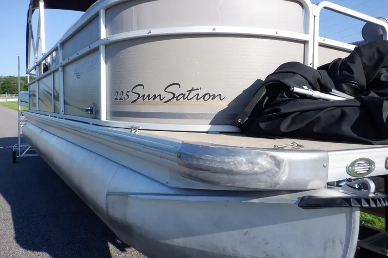 Slide: The Image of 2009 Premier 225 Sunsation LTD pontoon boat, side view, parked on pavement. - 7