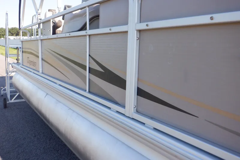 Slide: The Image of 2009 Premier 225 Sunsation LTD pontoon boat side view with sleek design and graphics. - 8