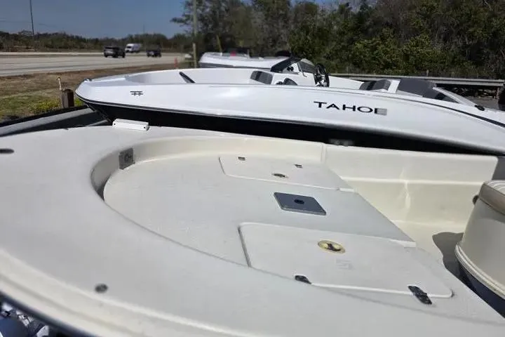 Slide: The Image of 2015 Carolina Skiff JVX Center Console boat, white deck, parked outdoors. - 7